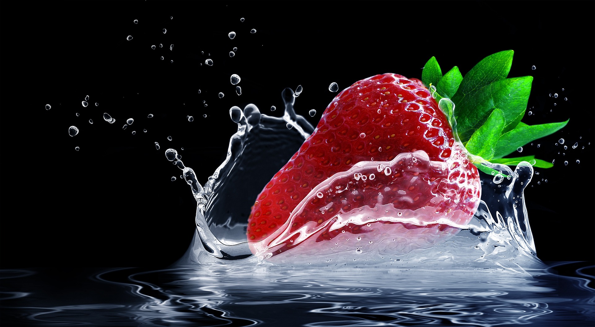 ripe red strawberry splashing in water